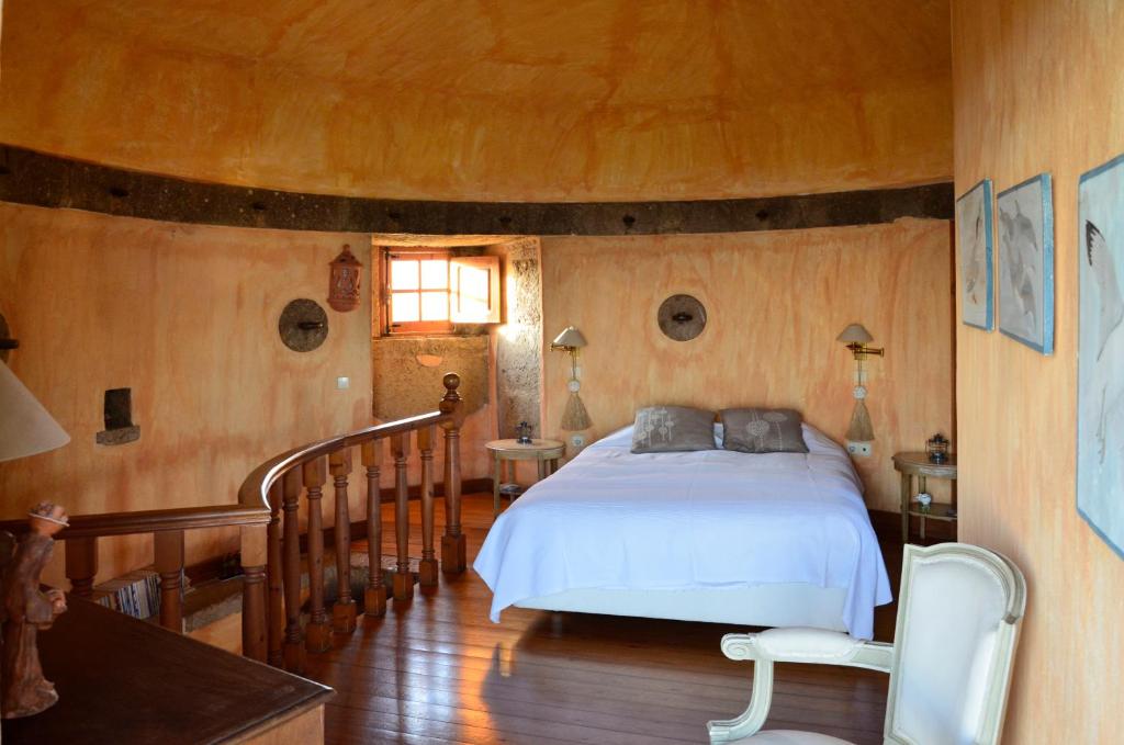 a bedroom with a bed in a room with wooden walls at Ha Mar ao Luar in Setúbal