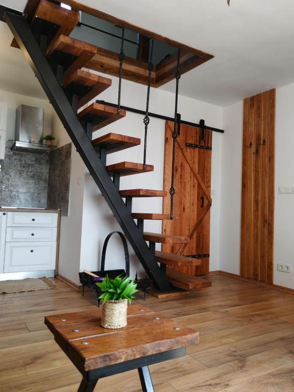 a staircase in a living room with a wooden table at Vinea holiday home in Jakopovec