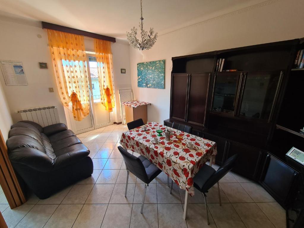 a living room with a table and a couch at Casa Lisa in Trieste