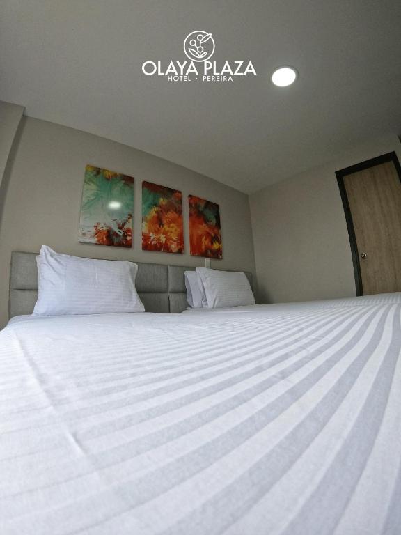 Postel nebo postele na pokoji v ubytování Hotel Olaya Plaza