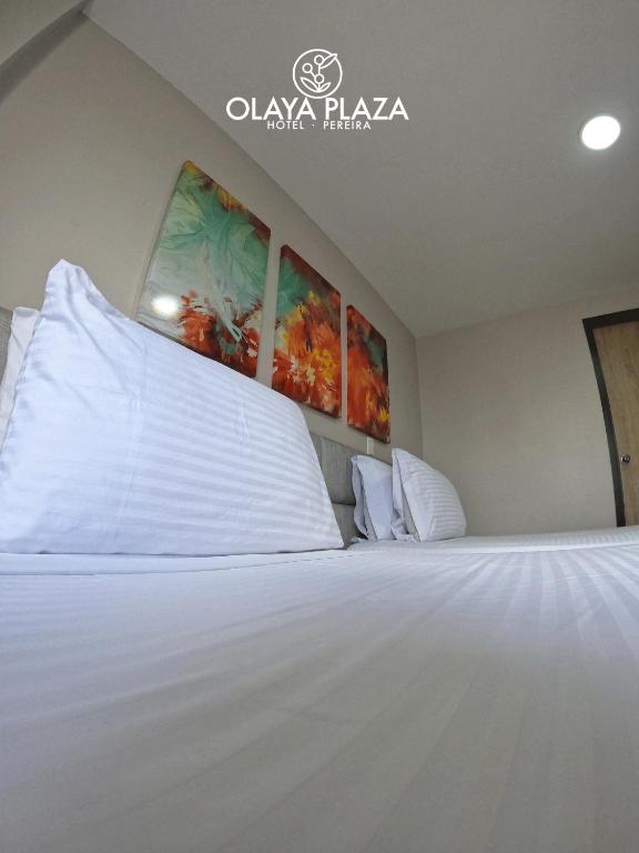 Postel nebo postele na pokoji v ubytování Hotel Olaya Plaza