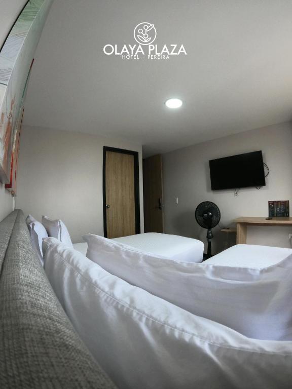 Postel nebo postele na pokoji v ubytování Hotel Olaya Plaza