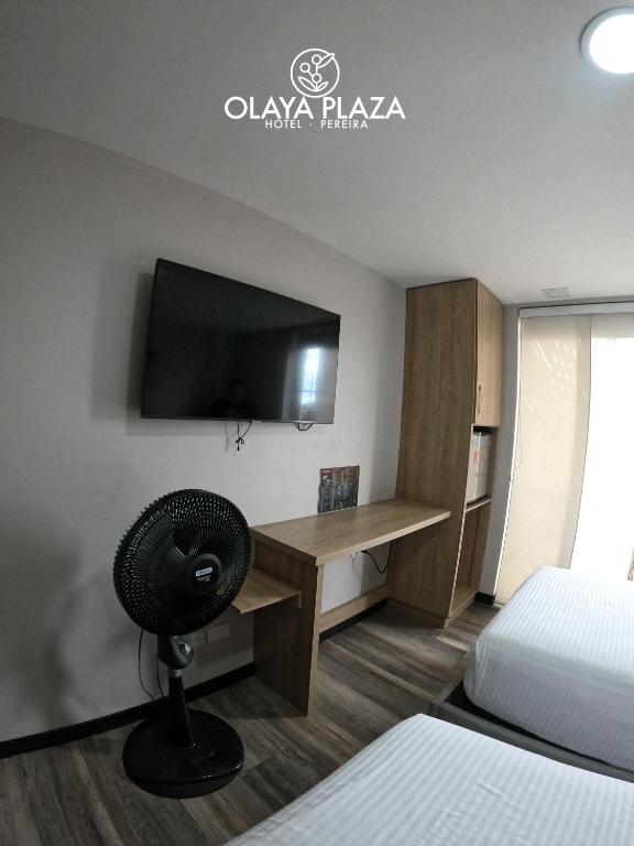 Postel nebo postele na pokoji v ubytování Hotel Olaya Plaza