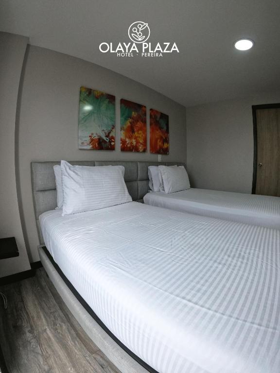 Postel nebo postele na pokoji v ubytování Hotel Olaya Plaza
