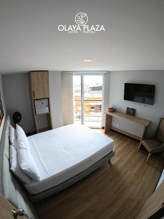 Postel nebo postele na pokoji v ubytování Hotel Olaya Plaza