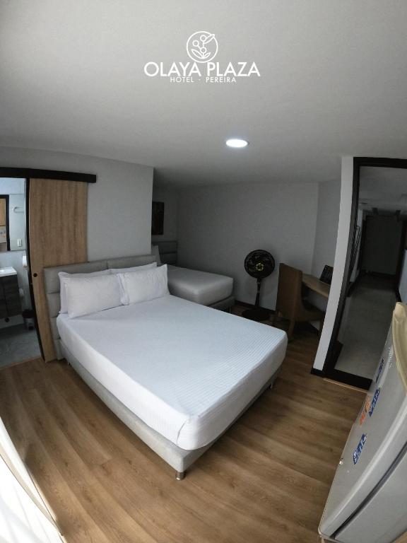 Postel nebo postele na pokoji v ubytování Hotel Olaya Plaza