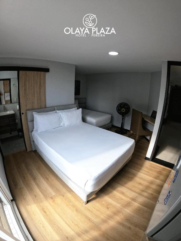 Postel nebo postele na pokoji v ubytování Hotel Olaya Plaza