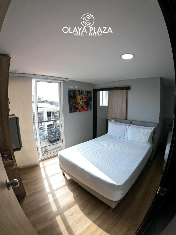 Postel nebo postele na pokoji v ubytování Hotel Olaya Plaza