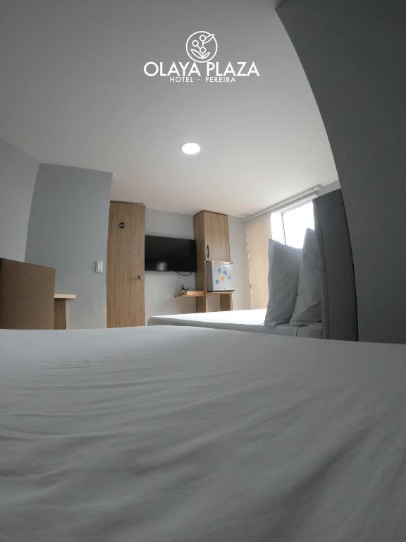 Postel nebo postele na pokoji v ubytování Hotel Olaya Plaza