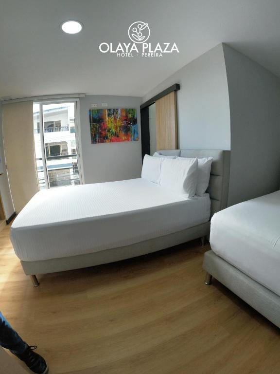 Postel nebo postele na pokoji v ubytování Hotel Olaya Plaza
