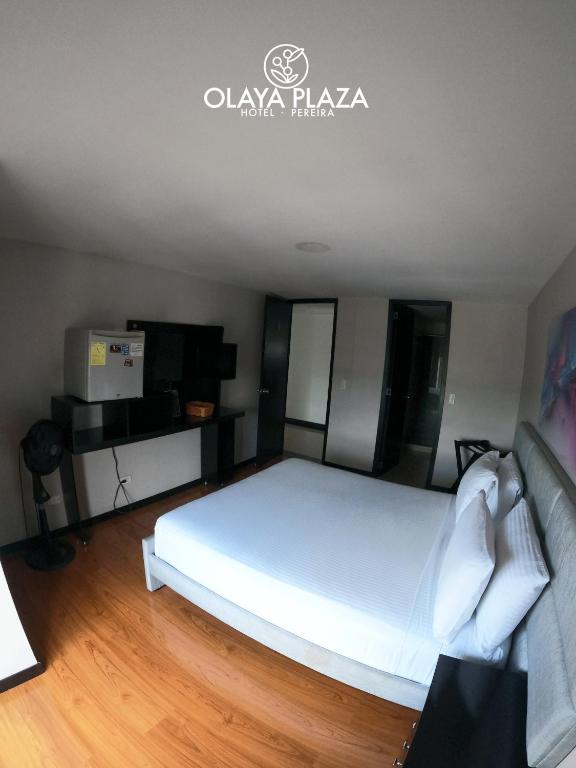 Postel nebo postele na pokoji v ubytování Hotel Olaya Plaza