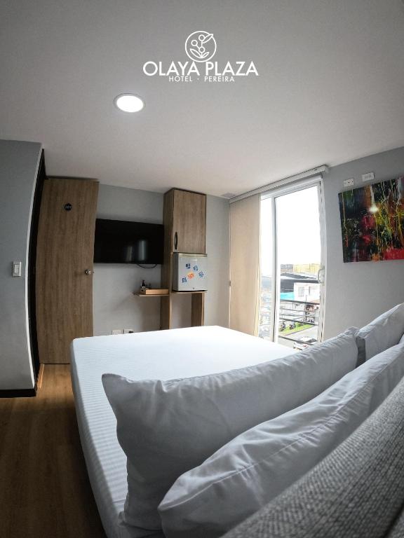 Postel nebo postele na pokoji v ubytování Hotel Olaya Plaza