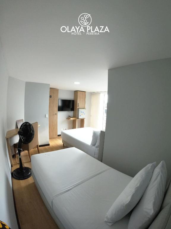 Postel nebo postele na pokoji v ubytování Hotel Olaya Plaza