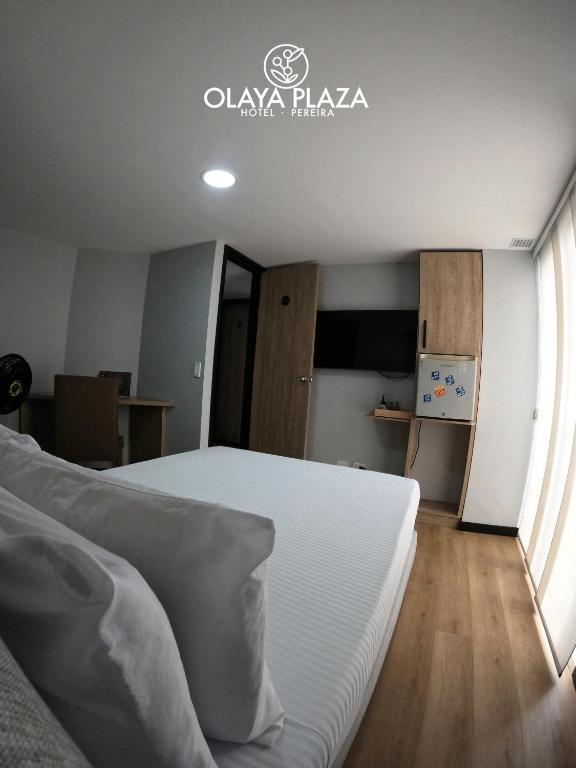 Postel nebo postele na pokoji v ubytování Hotel Olaya Plaza