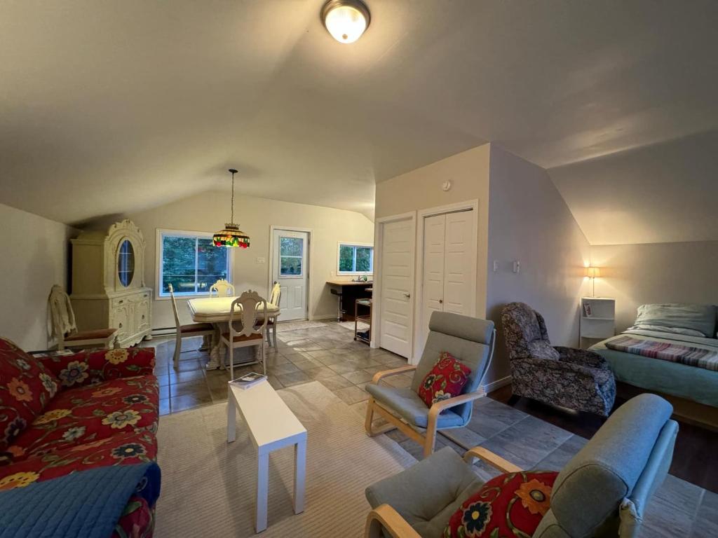 a living room with a couch and a table at Loft Nature Laurentides in Val-des-Lacs