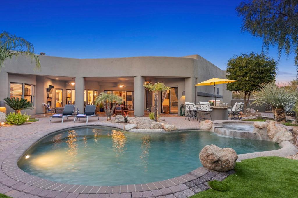 a house with a swimming pool in the yard at The Debonair Derby by PaseoHomesAZ with Heated Pool in Scottsdale