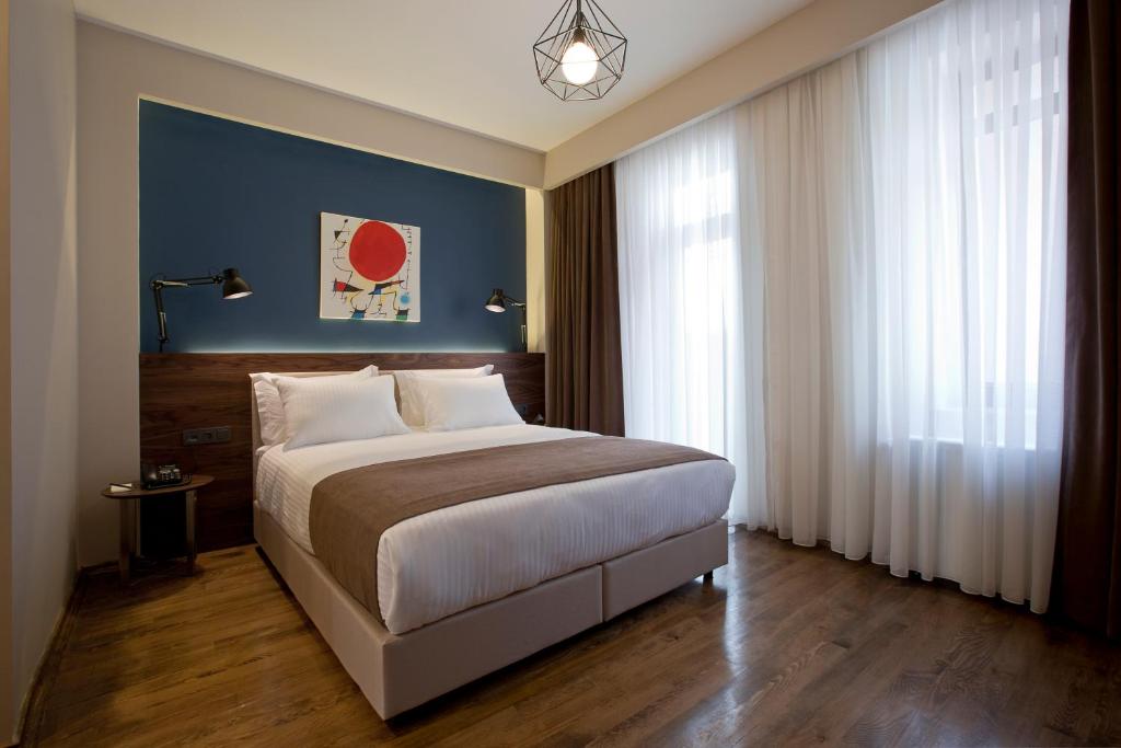 Postel nebo postele na pokoji v ubytování Snog Rooms & Suites