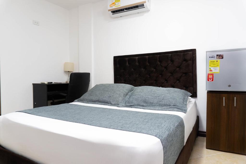 Postel nebo postele na pokoji v ubytování Hotel Palo Alto Laureles