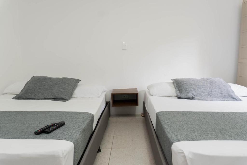 Postel nebo postele na pokoji v ubytování Hotel Palo Alto Laureles