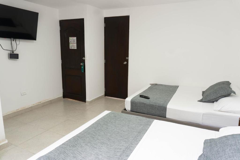 Postel nebo postele na pokoji v ubytování Hotel Palo Alto Laureles
