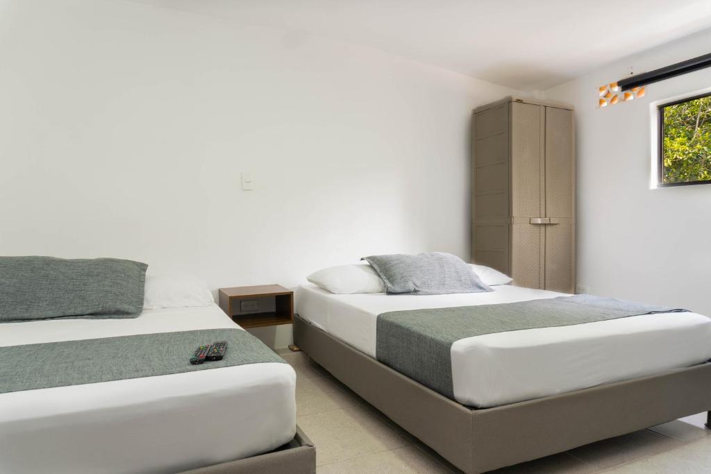 Postel nebo postele na pokoji v ubytování Hotel Palo Alto Laureles