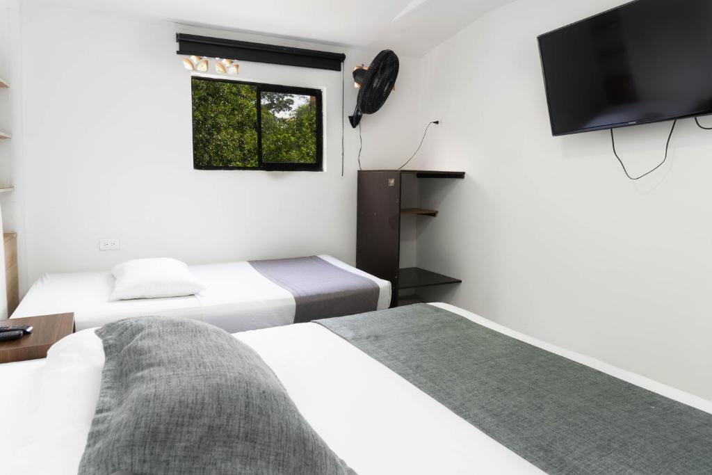 Postel nebo postele na pokoji v ubytování Hotel Palo Alto Laureles