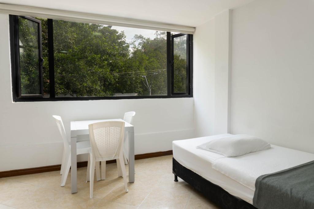 Postel nebo postele na pokoji v ubytování Hotel Palo Alto Laureles