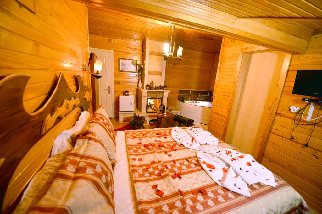 a bedroom with a bed with a chess board on it at Assortie La Villa Hotel in Ağva