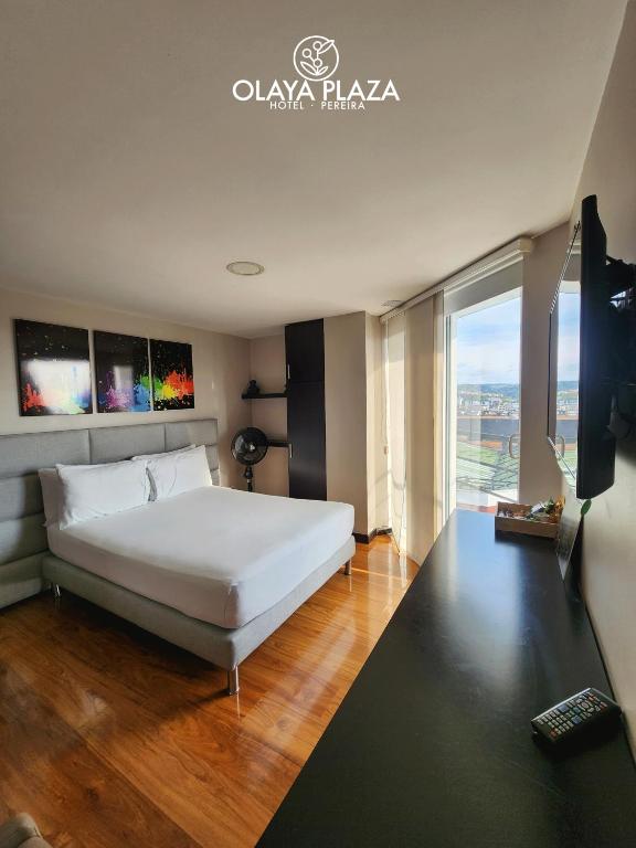 Postel nebo postele na pokoji v ubytování Hotel Olaya Plaza