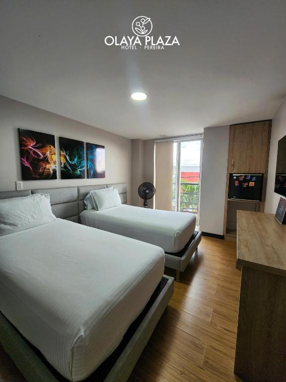 Postel nebo postele na pokoji v ubytování Hotel Olaya Plaza