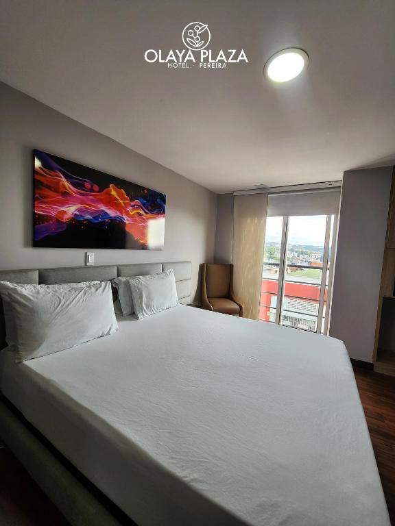 Postel nebo postele na pokoji v ubytování Hotel Olaya Plaza