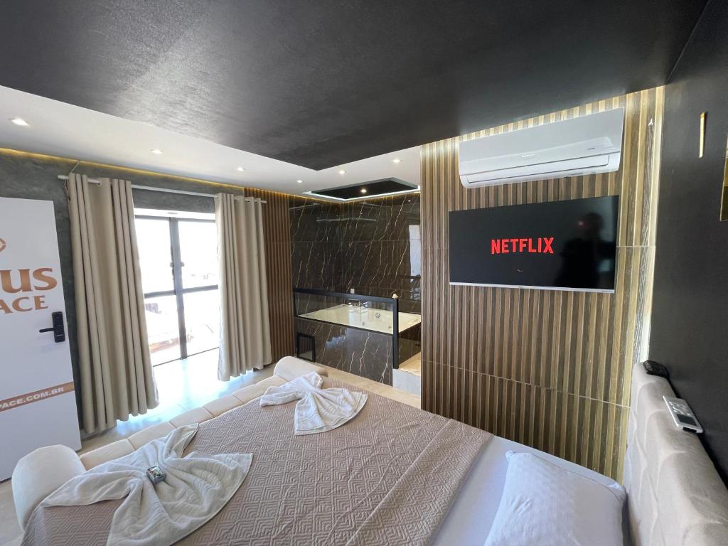 a hotel room with a bed and a kitchen at Suíte Gold com varanda e Hidro 302 in Santo Antônio do Descoberto