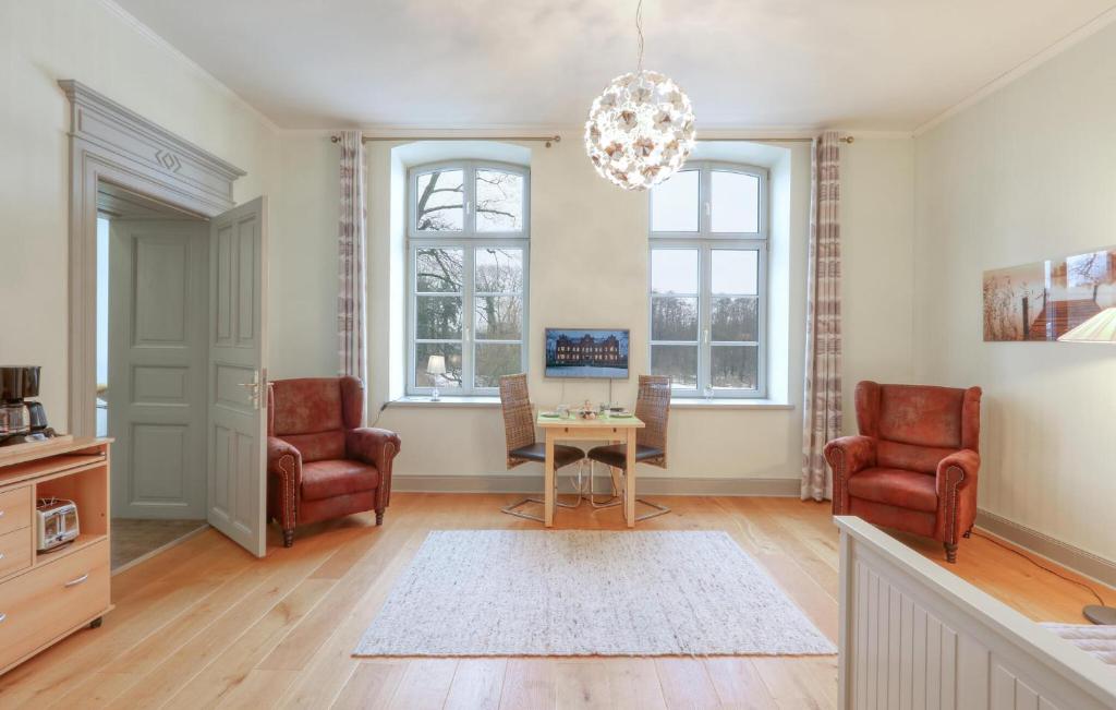 a living room with two chairs and a table at Gorgeous Apartment In Krakow Am See in Krakow am See