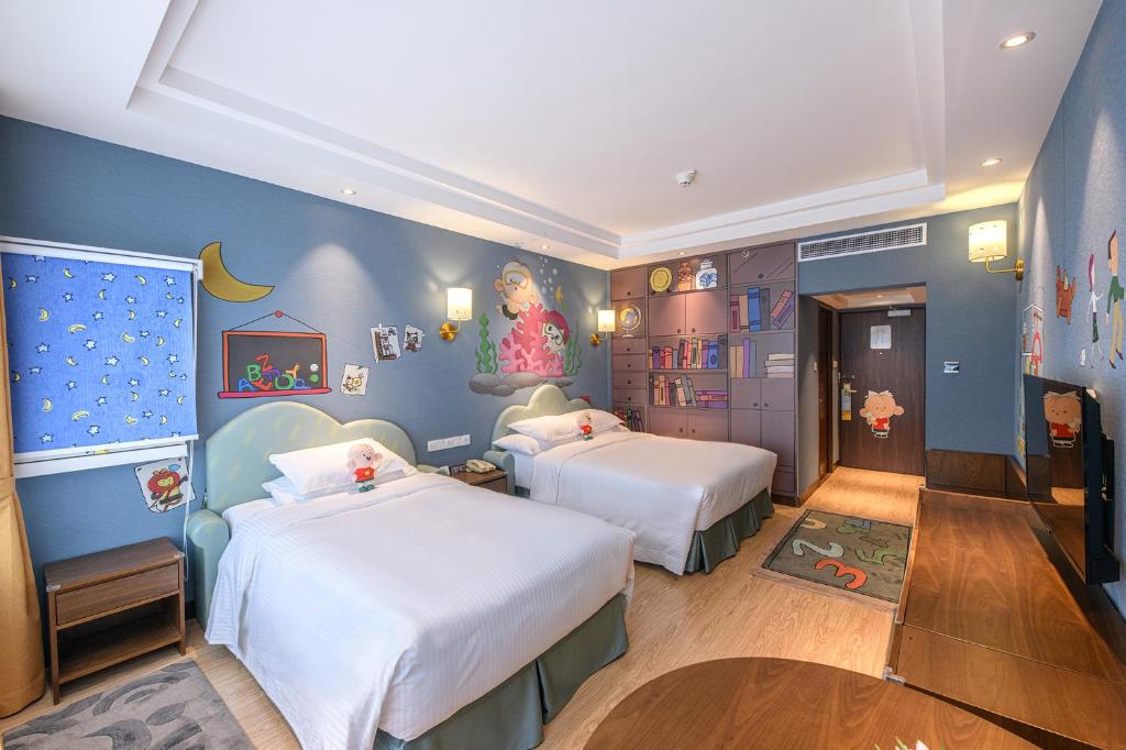 a childrens room with two beds and a mural at Crowne Plaza Shanghai by IHG in Shanghai