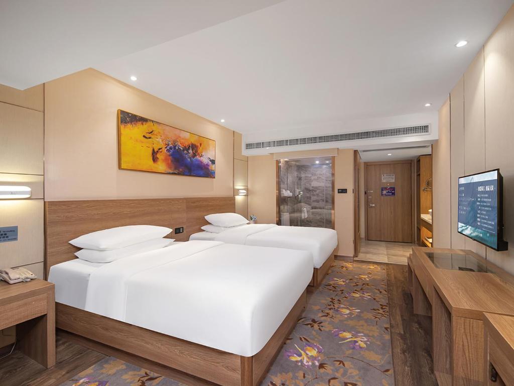 Postel nebo postele na pokoji v ubytování Guangzhou Baiyun Airport Renhe Cornet International Chain Hotel