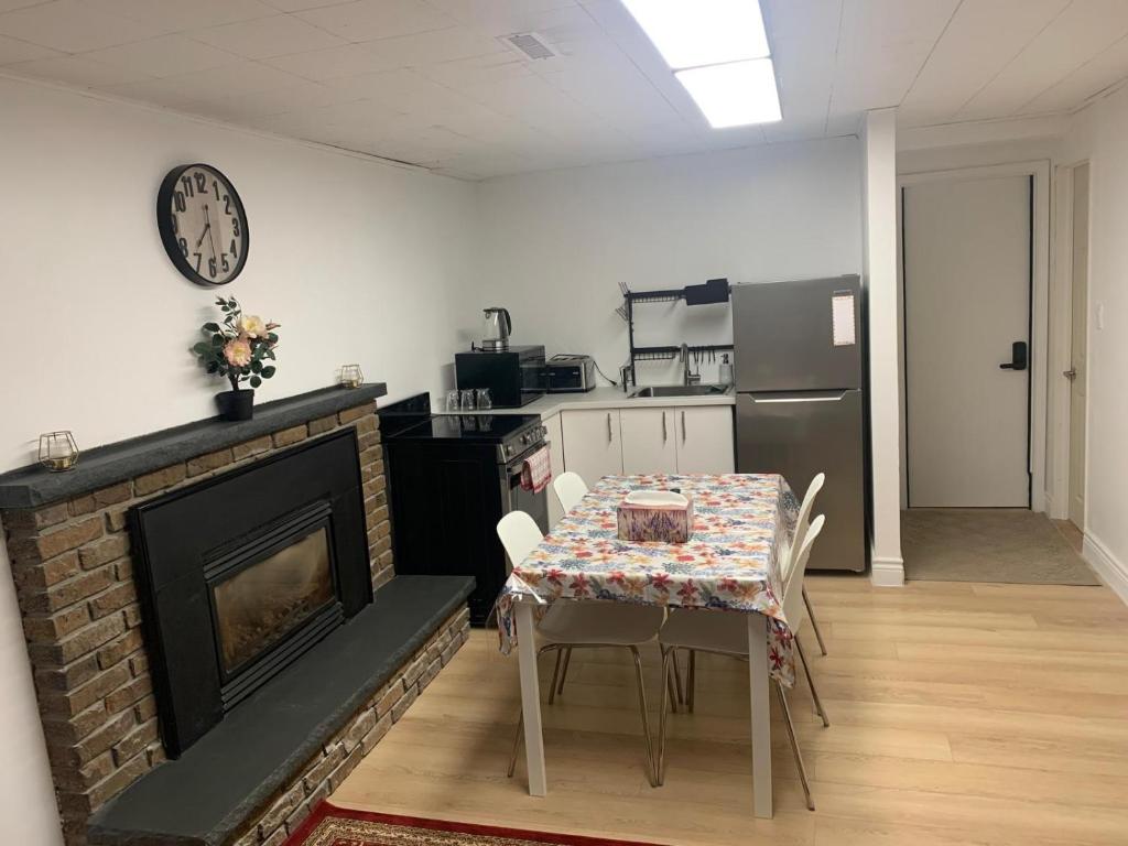 a kitchen and dining room with a table and a fireplace at Millpond Basement Units in Richmond Hill