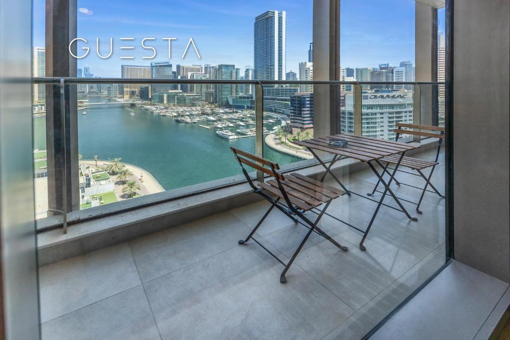 a balcony with a table and chairs and a view of a harbor at Sparkle Tower, Dubai Marina in Dubai