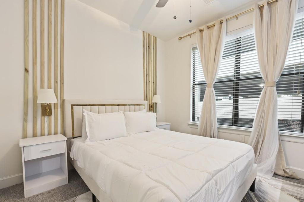 a white bedroom with a bed and a window at Sleeps 8 2B near Legacy West Toyota & The Star 2250 in Frisco
