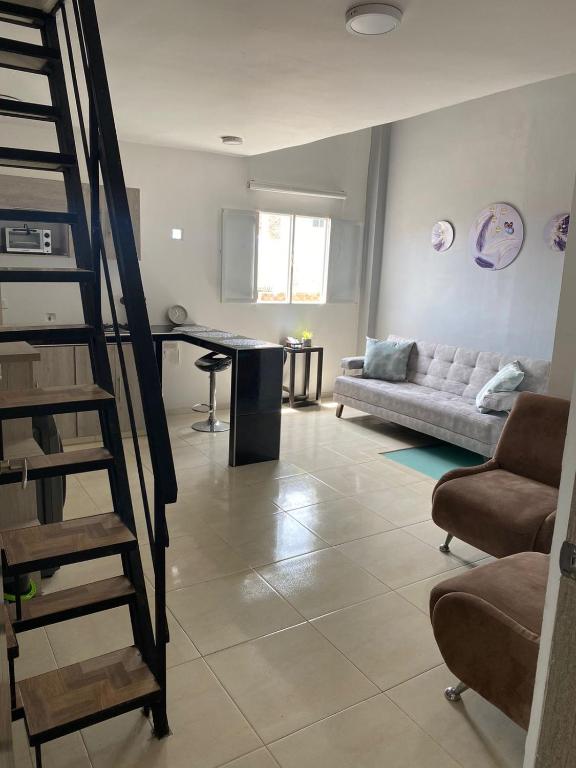 a living room with a couch and a table at Apartamento en Las Mercedes tipo Loft in Palmira
