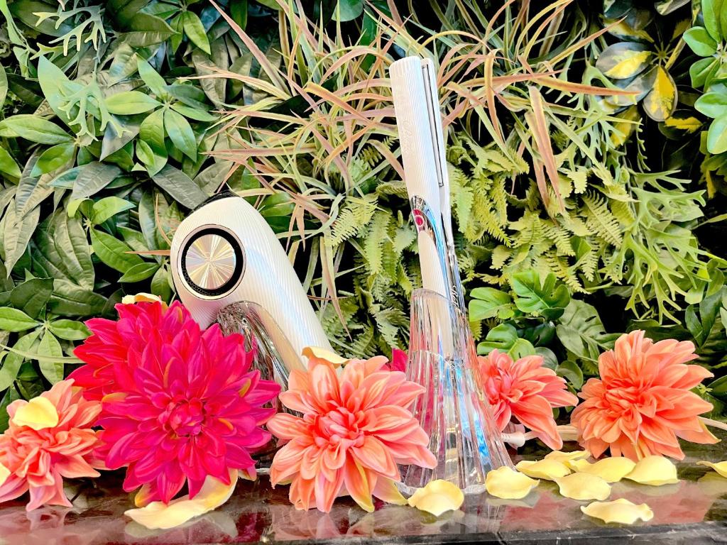 two toothbrushes and flowers sitting in a garden at Hotel Actel Nagoya Nishiki in Nagoya