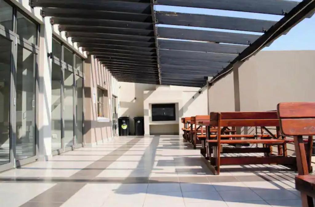 a row of benches on the side of a building at Stunning spacious Studio apartment in Sandton