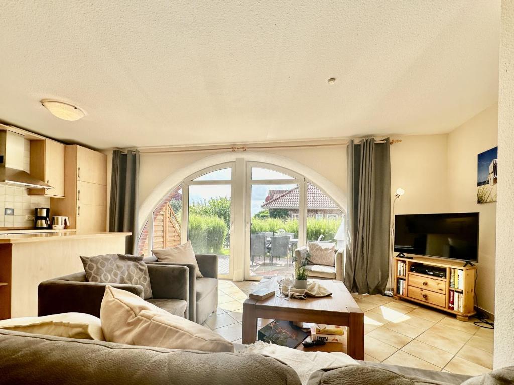 a living room with a couch and a table at Haus Emmi - Hooksiel in Wangerland