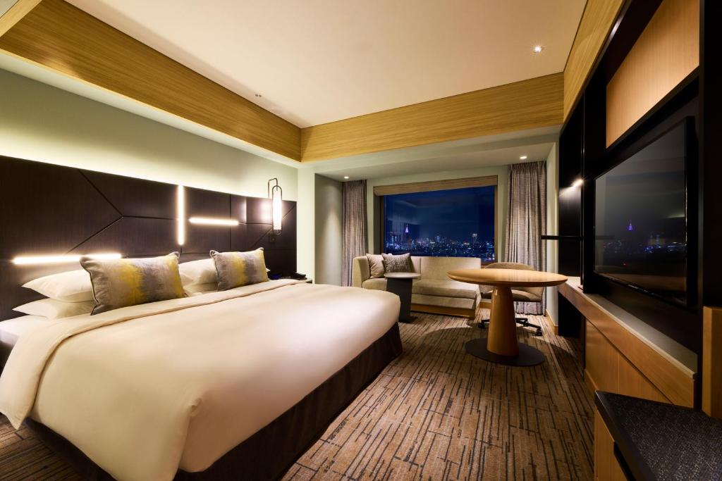 a hotel room with a large bed and a table at Cerulean Tower Tokyu Hotel, A Pan Pacific Partner Hotel in Tokyo
