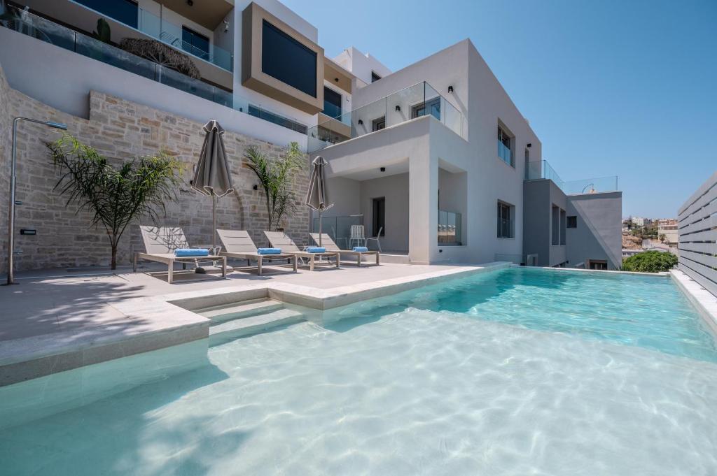 a swimming pool in the backyard of a house at ArtCotel Luxury Villa in Rethymno Town