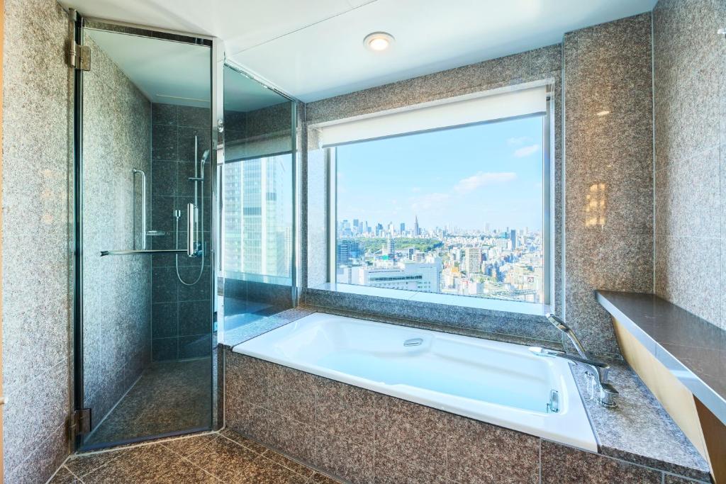 a bathroom with a bath tub and a window at Cerulean Tower Tokyu Hotel, A Pan Pacific Partner Hotel in Tokyo