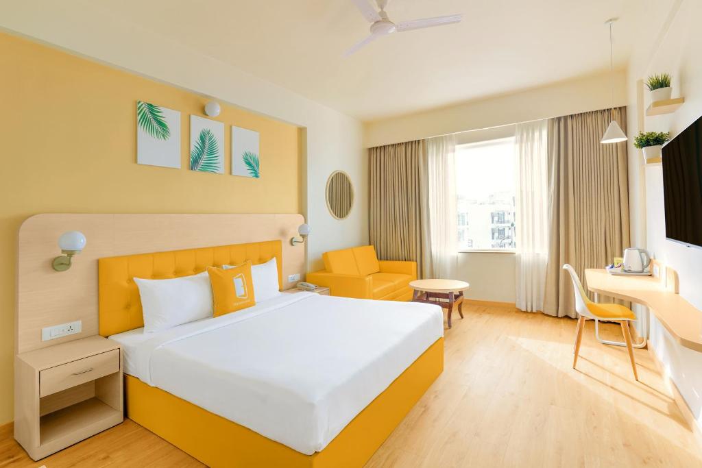Postel nebo postele na pokoji v ubytování Bloom Hotel Katra