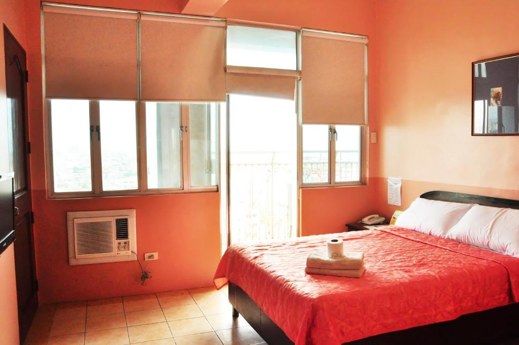 Postel nebo postele na pokoji v ubytování GV Tower Hotel