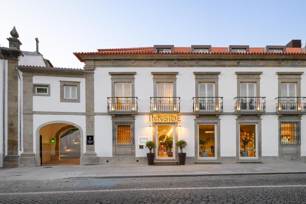 a large white building with a market sign on it at INNSiDE by Meliá Braga Centro in Braga