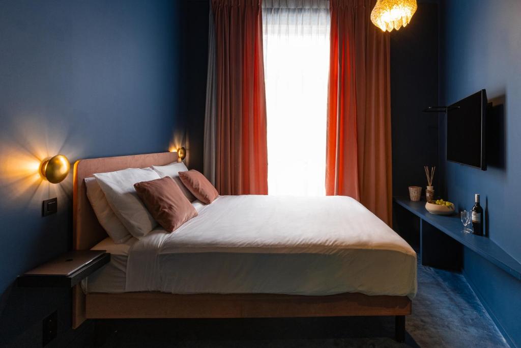 Postel nebo postele na pokoji v ubytování The Mila Hotel