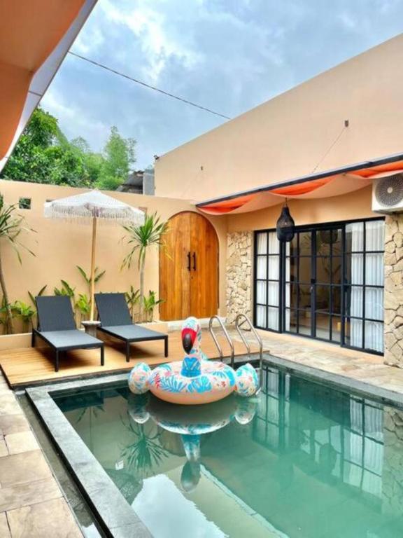 a house with a swimming pool and a house with a house at Sampai Villa Sahara in Yogyakarta
